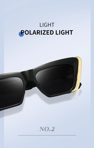 Close-up of black square polarized sunglasses with elegant gold metal trim on the temple