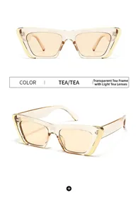 Detail view of tea brown cat-eye sunglasses with transparent frames and golden accents