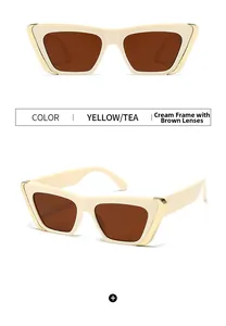 Macro view of retro cat-eye sunglasses with yellow frames, tea lenses and gold metal accents