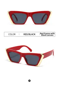 Detail of red cat-eye sunglasses with gold metal trim and dark grey lenses