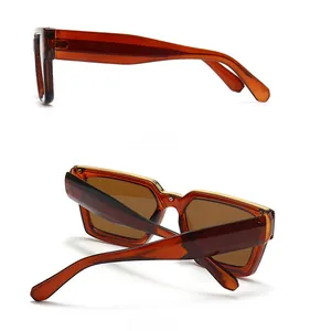 Detail view of amber square sunglasses featuring gold metal hinges and side profile
