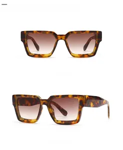 Detail view of square leopard print sunglasses with brown gradient lenses