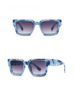Detail view of square blue marble frames with grey gradient lenses in multiple angles