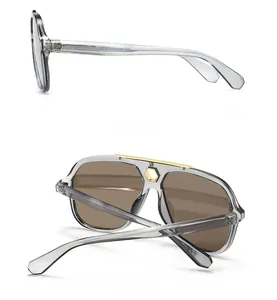 Detail of pilot sunglasses with metal top bar and transparent grey frame showing side and back