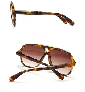 Detail of tortoise frame aviator sunglasses with gold top bar and gradient lenses