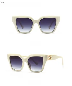 Beige oversized square sunglasses with gradient grey lenses and golden temple detail