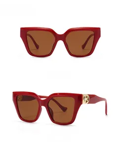 Modern retro oversized sunglasses in red tan with golden hinge logo and dark brown lens