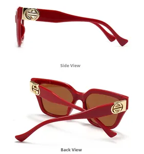Side and back view of oversized red sunglasses with gold logo detail on temples