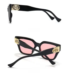 Detailed side and back view of oversized sunglasses with pink lenses and gold logo