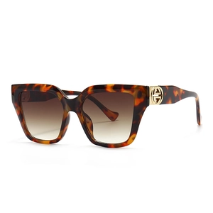 Modern oversized tortoiseshell sunglasses with gradient brown lenses and gold logo detail