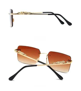 Detail showing golden leopard sculpture on temple of gradient brown lens sunglasses