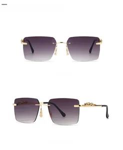 Detail of gold metal temples featuring an intricate leopard relief on rimless sunglasses