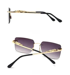 Detail view of golden cheetah leopard emblem on the temple of rimless sunglasses