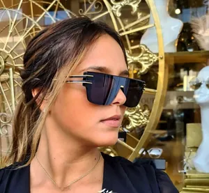 Chic oversized square sunglasses with dark lenses and elegant gold metal temples on model