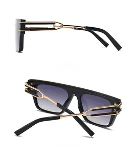 Side and back view of oversized black sunglasses with gold hollow metal temples