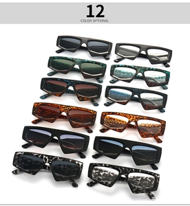 Flat lay of 12 multi-colored geometric sunglasses with thick frames and unique angles