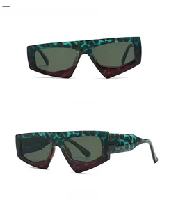 Detail view of large geometric sunglasses with green and purple zebra print frames