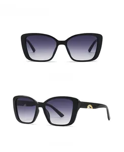 Front and 45-degree side views of black oversized sunglasses with gold metal trim