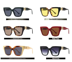 Detailed grid of oversized sunglasses in six color variations with gold metal logo