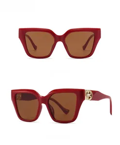 Front and 45-degree side view of oversized square red tea sunglasses with gold details