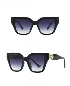 Front and 45-degree side views of black oversized sunglasses with gray gradient lenses