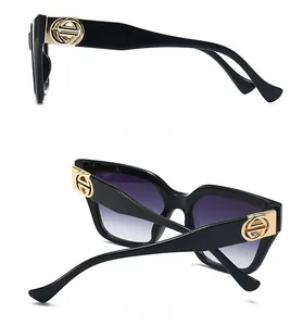 Side and back view of black square sunglasses featuring golden round logo on temples