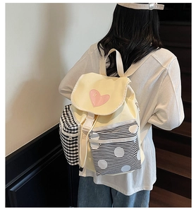 Detail view of Japanese style canvas backpack featuring contrast patterns and heart embroidery