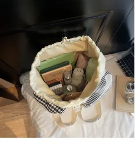 Detailed interior view of a large capacity checkered canvas backpack showing organized storage