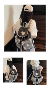 Detail view of contrast color backpack with heart patch and patterned side pockets