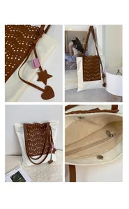Detail view of canvas tote bag with brown leather patchwork and heart star charms