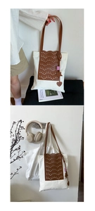 Detail view of white canvas bucket bag with brown laser-cut panels and fashion charms