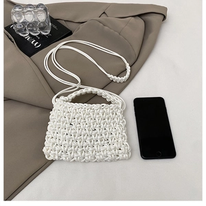 Detailed texture of white hand-woven mini crossbody bag with 3D braided pattern