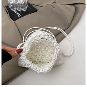 Macro detail of the white handwoven bucket bag showing premium textured rope craftsmanship