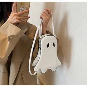 Detailed view of creative white ghost crossbody bag with wave hem and black eyes