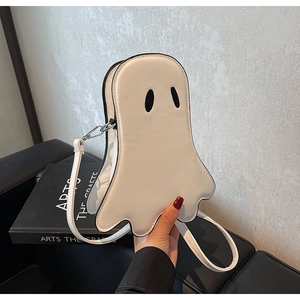 Close-up of white leather ghost crossbody bag with black embroidered eyes and silver hooks