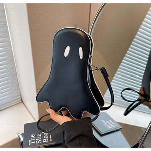Detailed close-up of a black ghost-shaped crossbody bag with white embroidered eyes