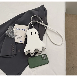 Minimalist white ghost crossbody bag made of matte PU leather on a styled flat lay