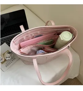 Top view of pink monogram tote bag interior showing large capacity and multi-compartments