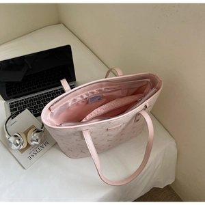 Top view of pink tote bag interior showing multiple compartments and satin lining