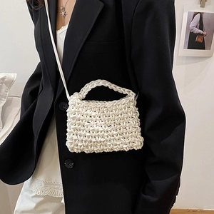 White hand-woven mini bag featuring chunky texture with top handle and crossbody strap