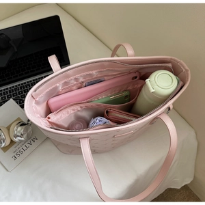 Internal view of pink tote bag showing large capacity compartments for daily essentials
