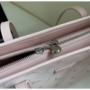 Close-up of pink tote bag with deer pattern and silver heart-shaped zipper slider