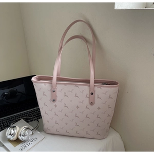 Detail of pink tote bag showing deer print pattern, metal zipper and reinforced straps