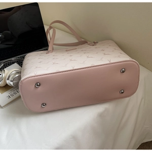 Detail view of pink deer pattern tote bag with silver protective metal feet on bottom