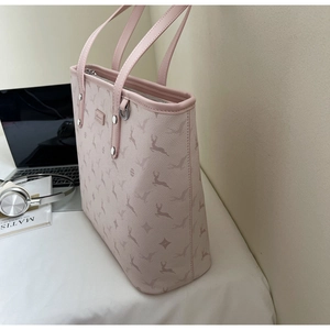 Detail of pink tote bag with deer prints featuring side metal D-ring and shoulder strap
