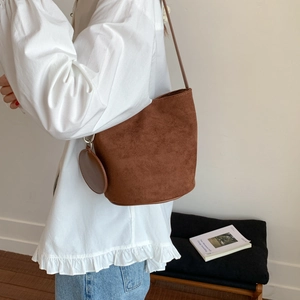 Retro caramel suede bucket bag with round coin purse accessory and long shoulder strap