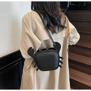 Detailed back view of a black crab-shaped crossbody bag with unique 3D claw design