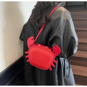 Detailed back view of a person wearing a creative red crab-shaped shoulder bag