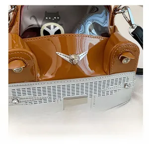 Close-up of caramel car bag with leopard logo, rhinestone lights, and black cat window