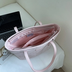 Pink leather tote bag with deer pattern, spacious interior with multiple zipper pockets